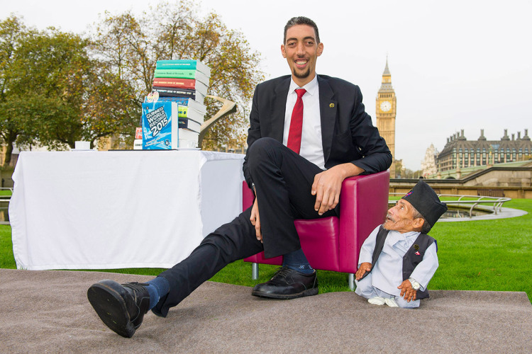 The VERY odd couple: Shortest man ever (21.5ins) meets tallest living person (8ft 1in) outside the Houses of Parliament for Guinness World Record Day